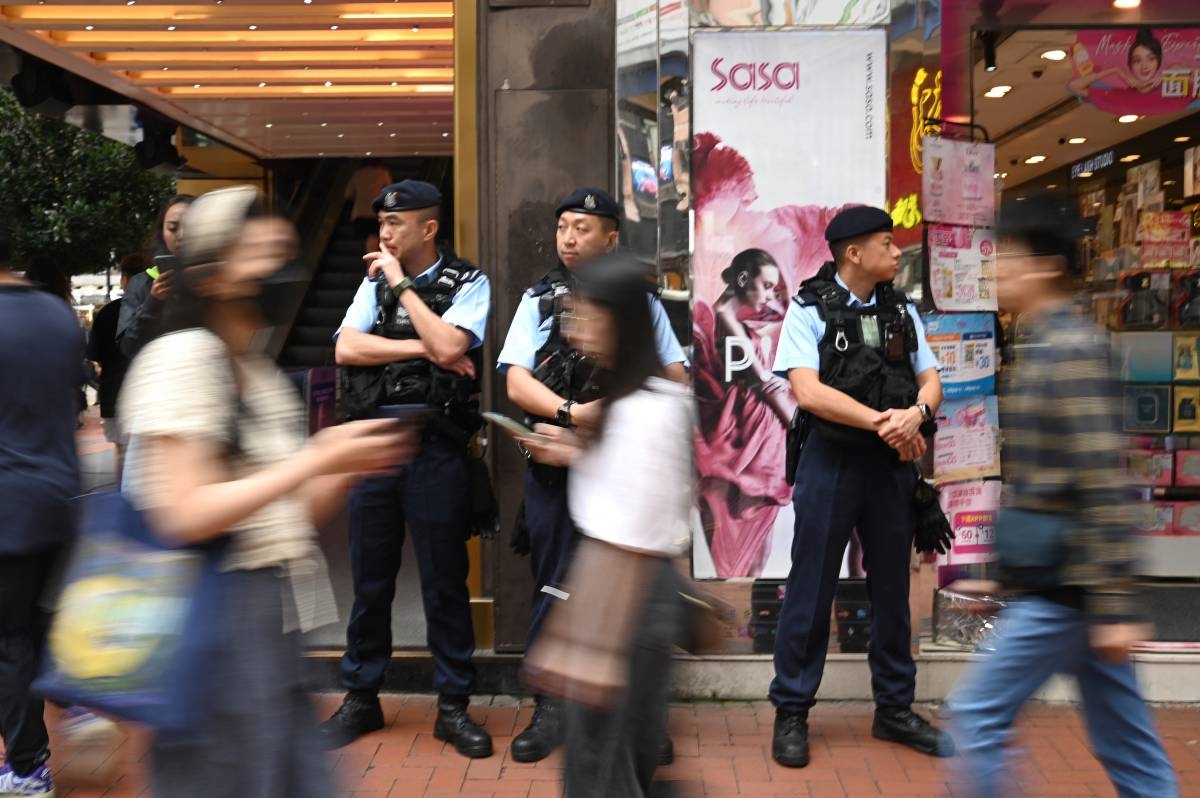 Police keep watch on a street in the Causeway Bay district of Hong Kong on June 4, 2024. Police patrolled on June 4 around a Hong Kong park, once the site where tens of thousands would gather for an annual memorial of the Tiananmen Square crackdown, on the look-out for hints of remembrance of its 35th anniversary. (Photo by Peter PARKS / AFP)