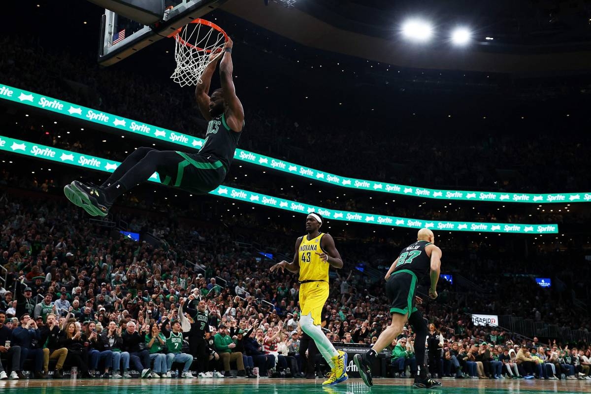 BIG-TIME DUNK Jaylen Brown of the Boston Celtics dunks the ball over the trailing Tyrese Haliburton of the Indiana Pacers as teammate Jordan Walsh walks away during the first quarter at TD Garden on Dec. 27, 2024, in Boston, Massachusetts. AFP PHOTO