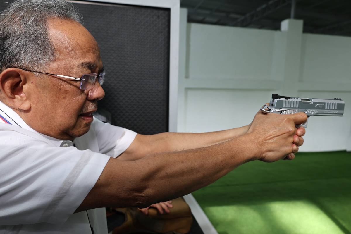 READY, AIM Subic Bay Metropolitan Authority chairman and administrator Eduardo Jose Aliño takes aim at the target as he tests his shooting skills at the newly opened modern firing range at the Subic Bay Freeport Zone on Jan. 7, 2025. PHOTO BY MAHATMA RANDY DATU