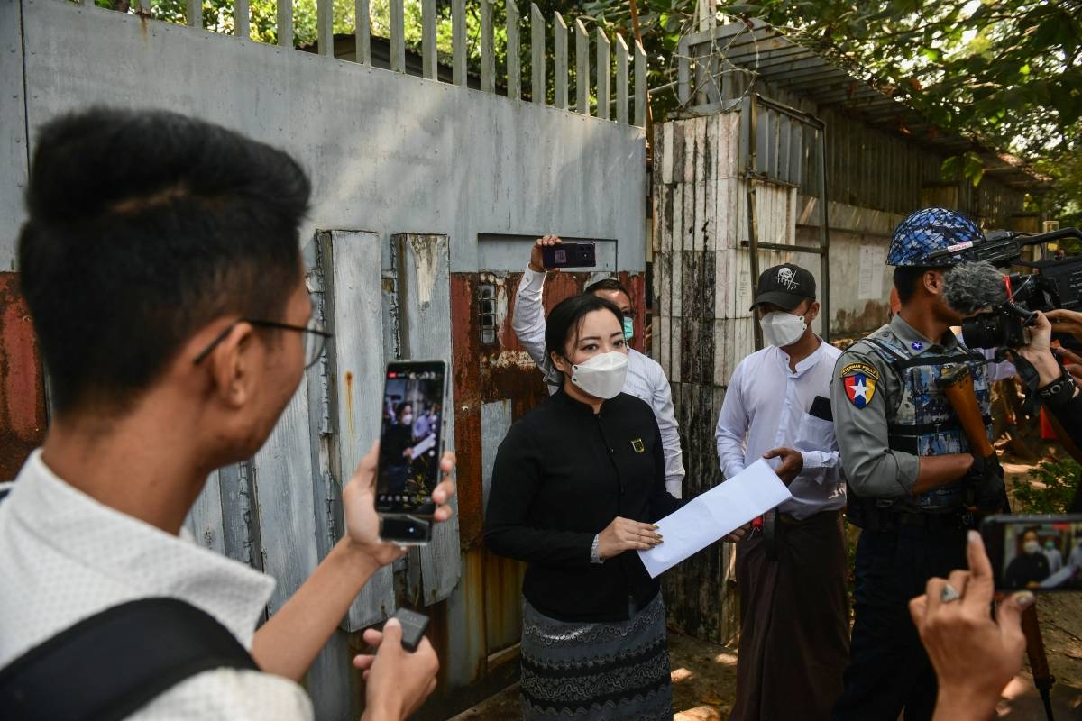 An auction official reads a statement outside the gate of the family house of detained Myanmar civilian leader Aung San Suu Kyi in Yangon on February 5, 2025, during an attempt to sell the lakeside mansion. AFP PHOTO