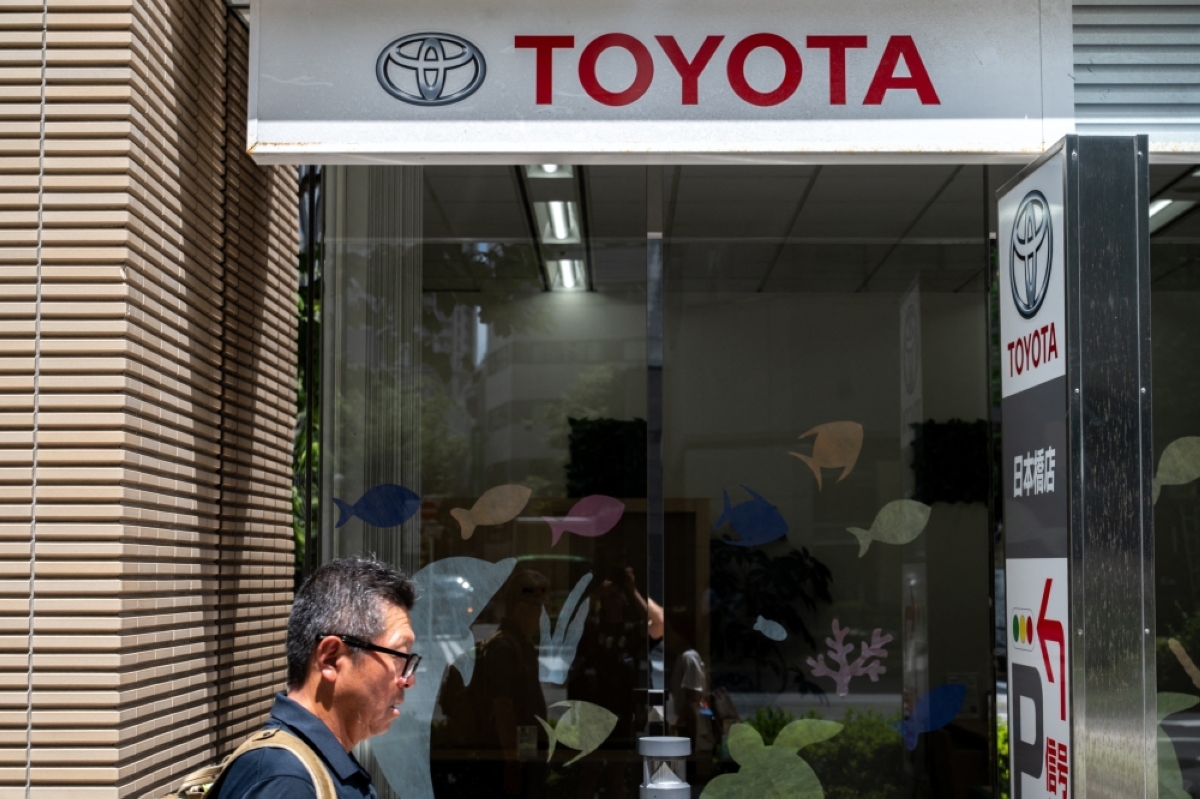 OPTIMISTIC A Toyota logo is seen on the side of a store in Tokyo on Aug. 4, 2026. The Japanese automotive giant raised its annual forecast despite a drop in its quarterly profit. AFP PHOTO 