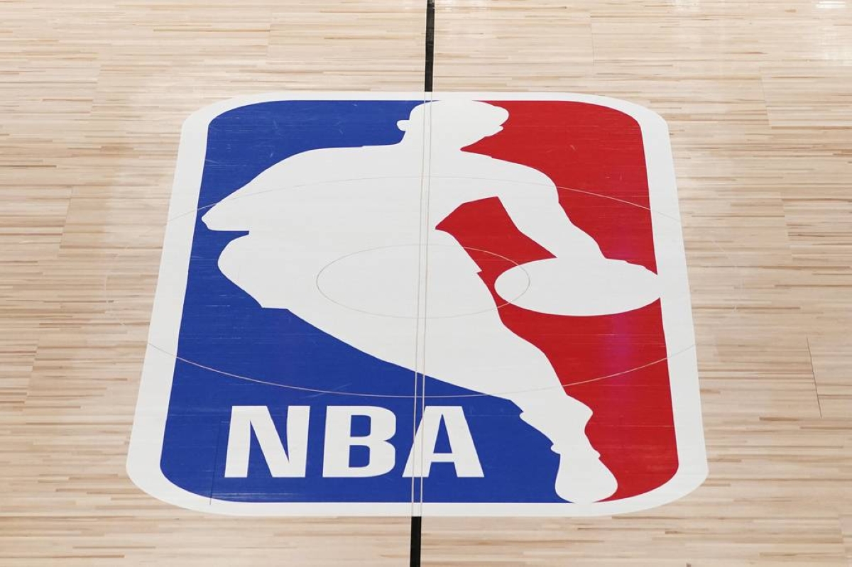 FILE - The NBA logo in shown on a basketball court in Lake Buena Vista, Fla., on Aug. 28, 2020. (AP Photo/Ashley Landis, Pool, File)