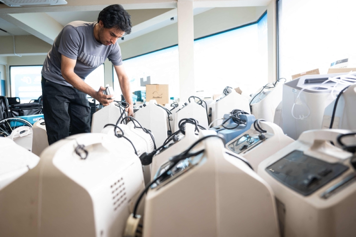 DEMAND RISES A technician inspects oxygen concentrators awaiting repair and cleaning at a medical supply warehouse in Kuala Lumpur on Oct. 15, 2026. AFP PHOTO