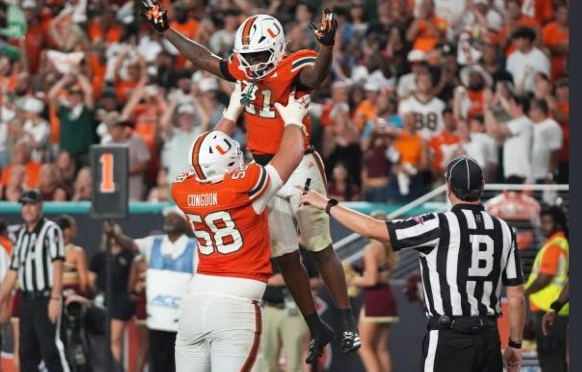 Miami running back Javian Mallory (21) celebrates with offensive lineman Ben Congdon (58) after scoring a touchdown during the second half of an NCAA college football game against Florida State, Saturday, Oct. 17, 2026, in Miami Gardens, Fla. (AP Photo/Lynne Sladky)