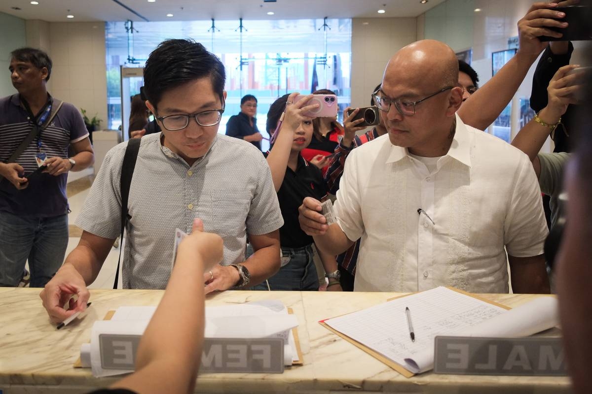 Podcaster Daniel Lawrence Vivar, left, and his legal counsel Pio Garayblas, arrive at the National Bureau of Investigation (NBI) headquarters in Pasay City, on Oct. 20, 2026. Vivar appeared before the agency in response to a subpoena following complaints over controversial and offensive comments made on the 'Machong Chismisan' podcast regarding Joshua Aquino, a person with a disability, and the son of actress--host Kris Auino. PHOTOS BY J. GERARD SEGUIA