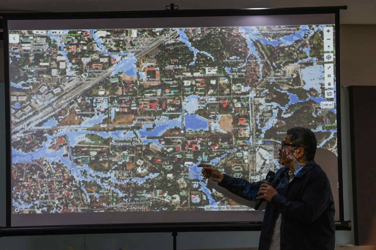 Project NOAH Executive Director Dr. Mahar Lagmay presents a historical flood hazard map of Quezon City, including UP campuses, highlighting flood-prone areas and underscoring the importance of rainwater management and flood mitigation measures. MMDA Flood Control and Sewerage Management Office Mark Edmon Navarro, MMDA Chairman Don Artes, University of the Philippines President Angelo Jimenez and Lagmay sign the Memorandum of Understanding for the implementation and construction of a rain impounding facility inside the campus at the UP Asian Institute of Tourism in Diliman, Quezon City on Wednesday, October 21, 2026. PHOTOS BY JOHN ORVEN VERDOTE