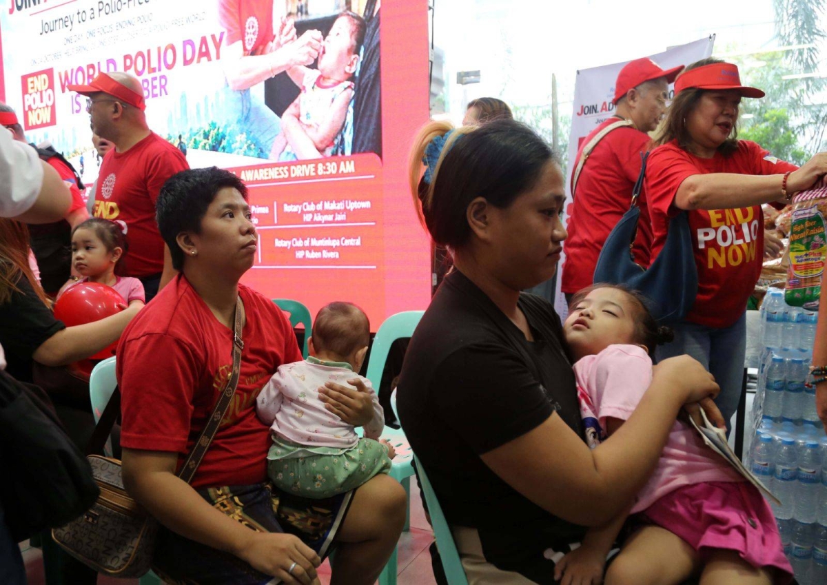 A child receives oral polio vaccine drops  while being held by a parent at the Parañaque City Hall on Oct. 24, 2026. The activity, organized by Rotary District 3830, aims to protect children against polio and encourage parents to have their children immunized. The initiative coincides with World Polio Day, Oct. 24, to highlight global efforts to eradicate the disease. PHOTOS BY RENE H. DILAN