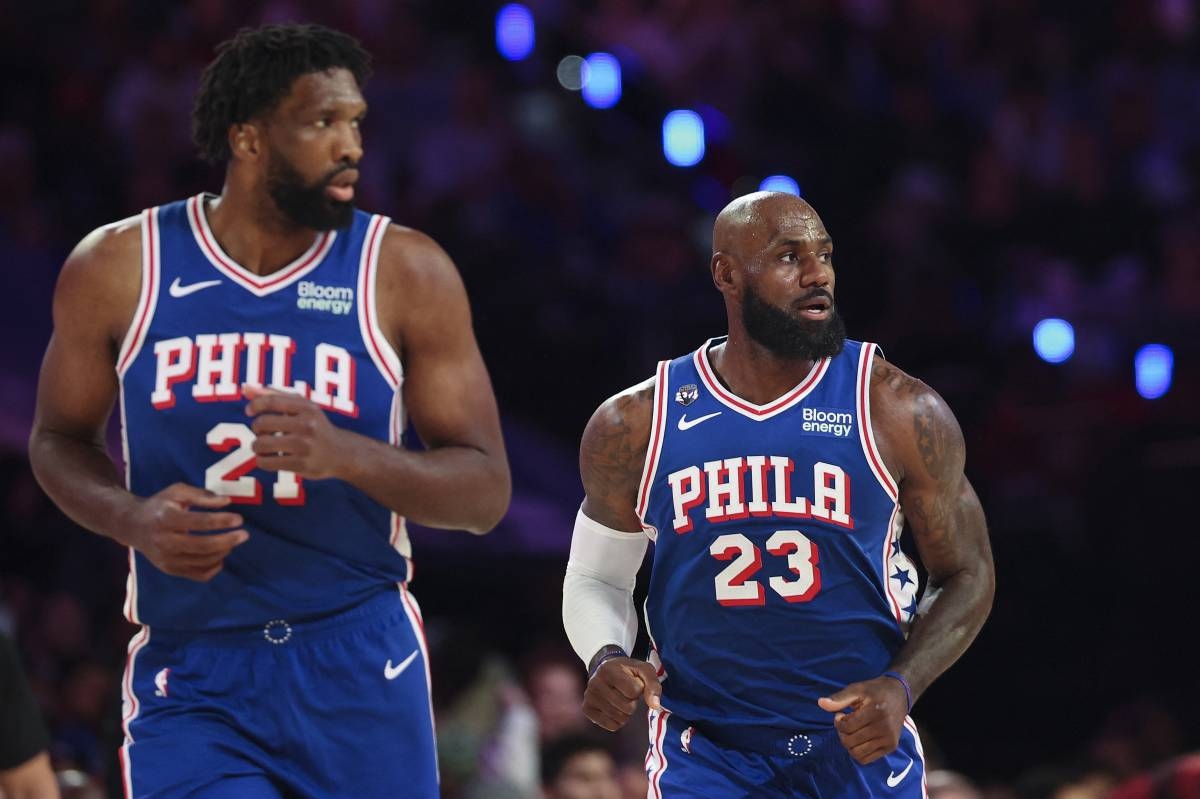 PHILADELPHIA, PENNSYLVANIA - OCTOBER 22: LeBron James #23 and Joel Embiid #21 of the Philadelphia 76ers look on during a game against the Cleveland Cavaliers at Xfinity Mobile Arena on October 22, 2026 in Philadelphia, Pennsylvania. NOTE TO USER: User expressly acknowledges and agrees that, by downloading and or using this photograph, User is consenting to the terms and conditions of the Getty Images License Agreement.   Emilee Chinn/Getty Images/AFP (Photo by Emilee Chinn / GETTY IMAGES NORTH AMERICA / Getty Images via AFP)