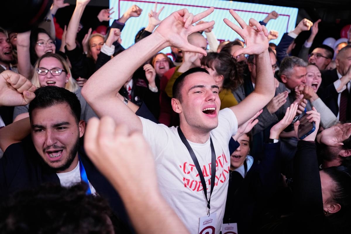 Candidates of the Students' List celebrate on stage along with staff members after polls closed in the parliamentary election in Belgrade, Serbia, Sunday, Oct. 25, 2026. (AP Photo/Petr David Josek)