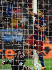 Barcelona’s Uruguayan forward Luis Suarez (right) scores past Sporting Gijon’s goalkeeper Ivan Cuellar during the Spanish league football match FC Barcelona vs Real Sporting de Gijón at the Camp Nou stadium in Barcelona on Sunday.  AFP PHOTO