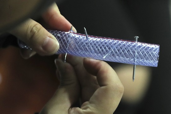 A pro-democracy protester makes nail roadblocks inside the campus of the University of Hong Kong, early Thursday, Nov. 14, 2019. (AP Photo/Kin Cheung)