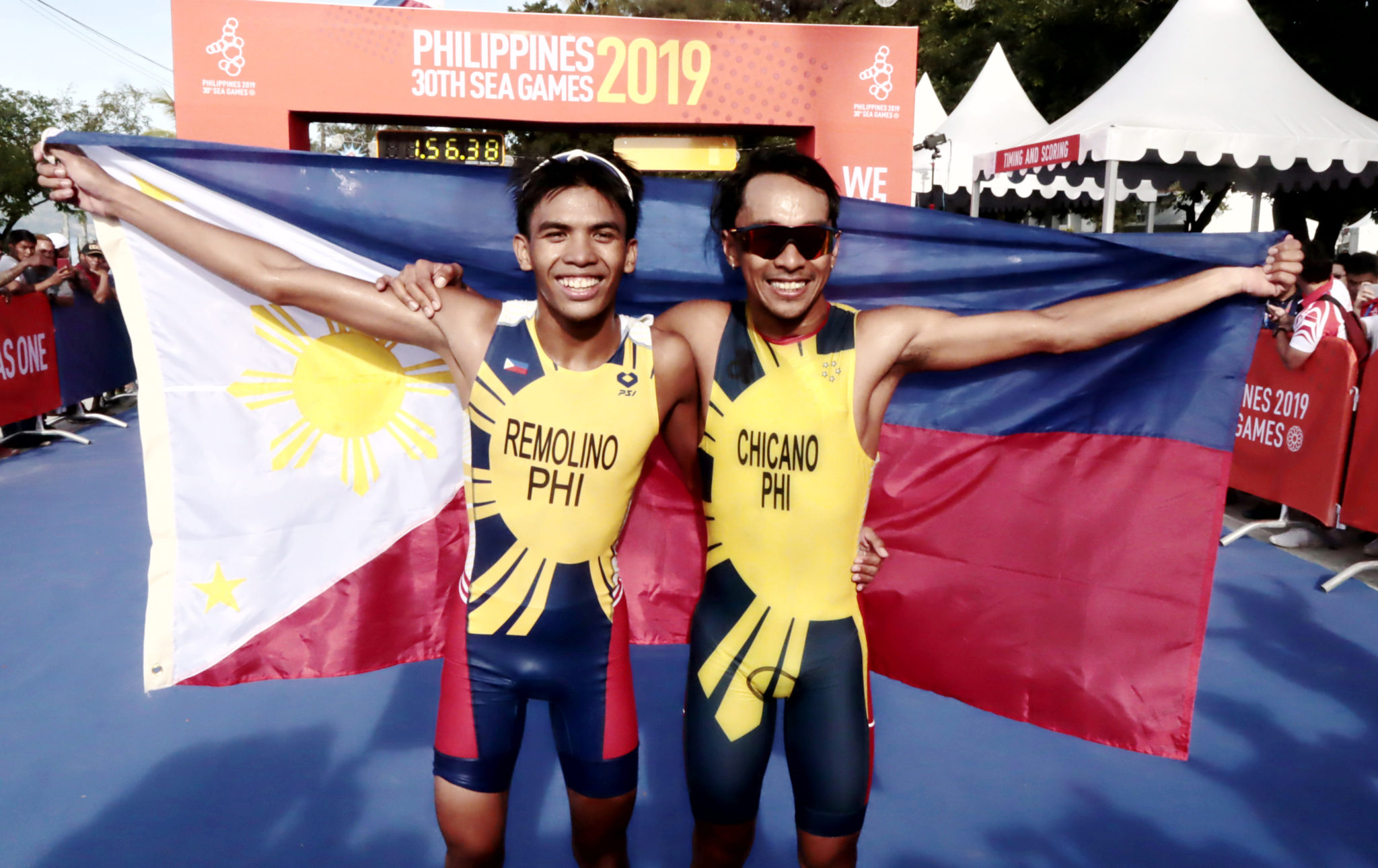 The Philippines' John Leerams Chicano celebrates after winning the gold in the men's triathlon in Subic, Zambales on Sunday. Kim Remolino bagged the silver medal in the same event. PHOTO BY ROGER RAÑADA